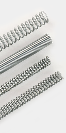 photograph of a selection of Springmasters' range compression springs supplied in lengths of 12 inches